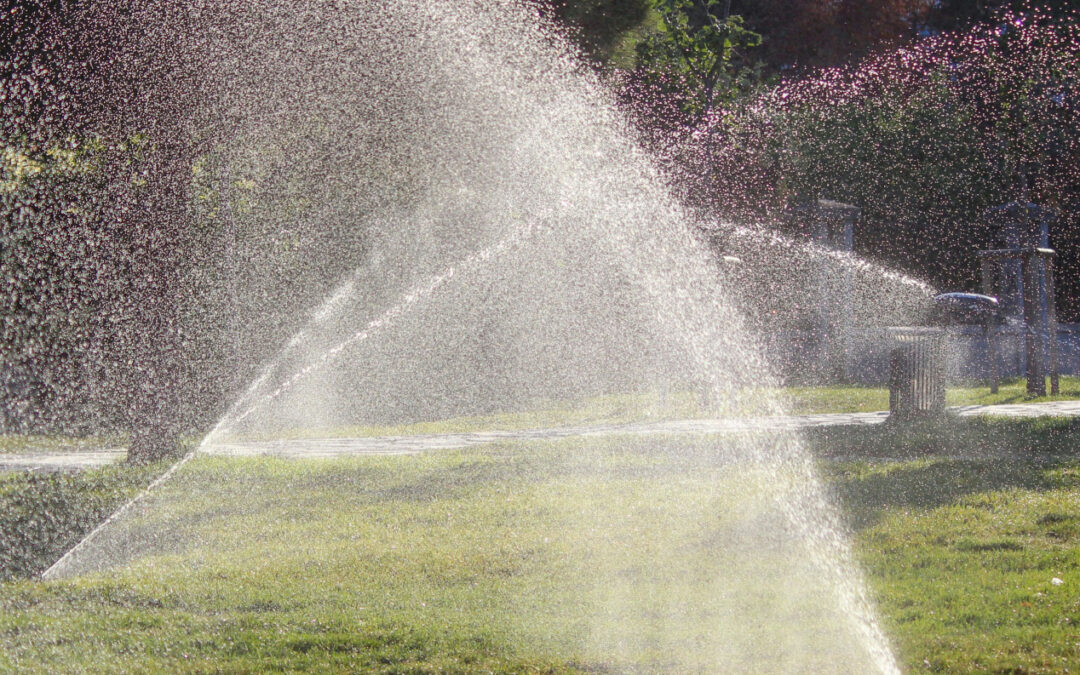 sprinkler system turned on watering grass